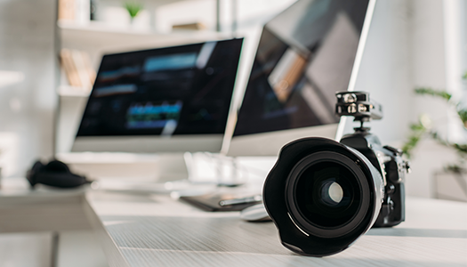 camera on desk beside computer